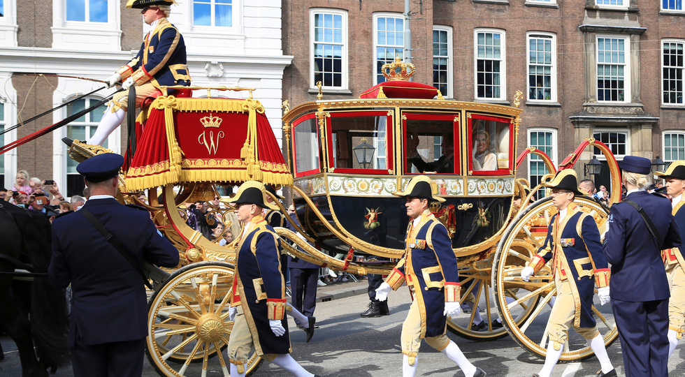 The Hague, The Netherlands - September 18, 2018: The glass carriage with Queen Maxima and King Willem-Alexander waving to the crowd on Prinsjesdag, the official opening of parliament